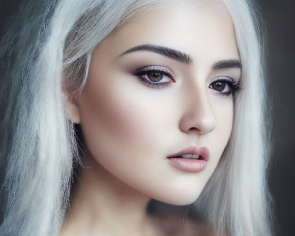 Portrait of a person with long silver hair and striking makeup-enhanced eyes