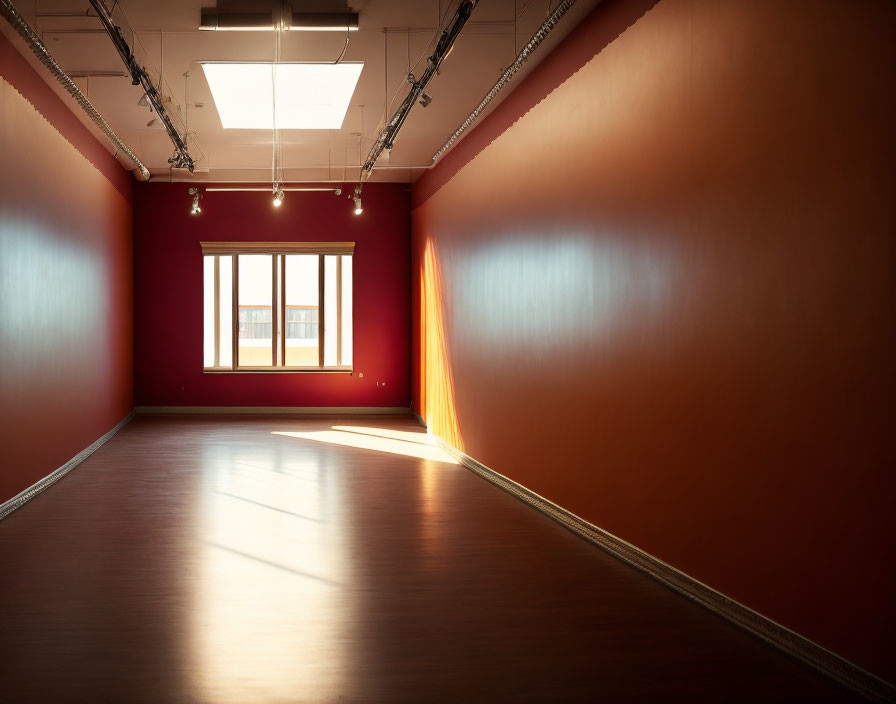 Terracotta-walled room with wooden floor, ceiling lights, and sunlight casting shadows