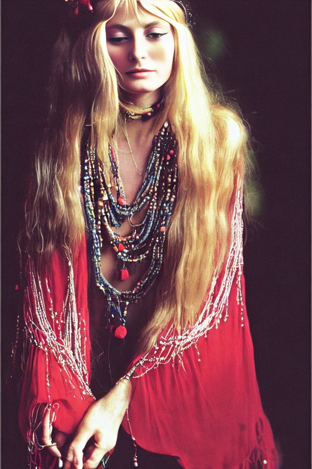 Blonde woman in red boho blouse with layered necklaces