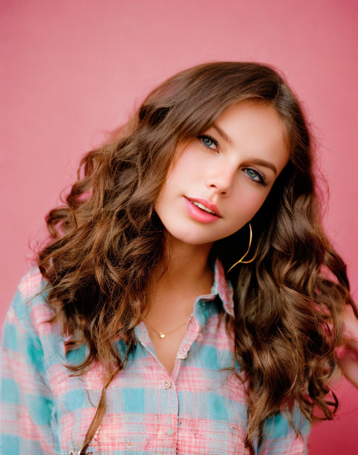 Curly Haired Woman in Plaid Shirt on Pink Background