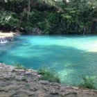 Tranquil Turquoise Natural Pool with Waterfall in Forest Setting