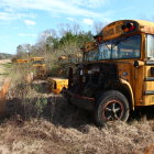 Abandoned yellow tractor in dried-up muddy terrain