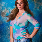 Long-haired woman in sheer blue top and jeans against abstract blue background with painterly effect