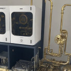 Saxophone beside white cabinet with mechanical parts and brass instruments displayed.