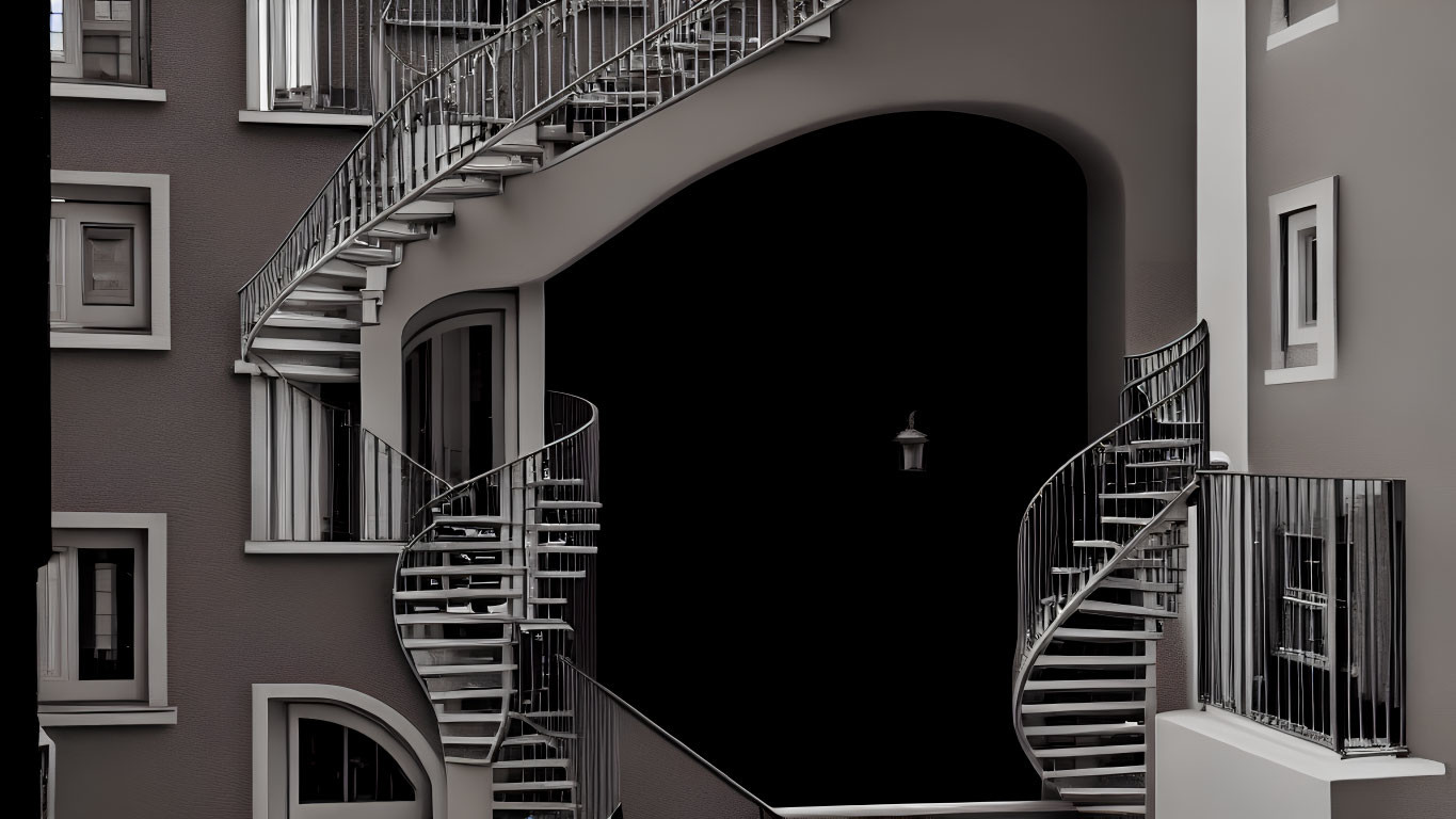 Symmetrical swirling staircases at arched entrance