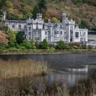 Mystical castle in vibrant forest with cascading waterfalls