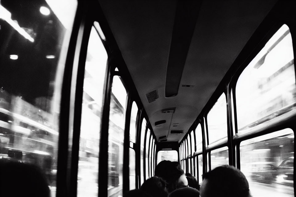 Monochrome bus interior with blurred city view through windows