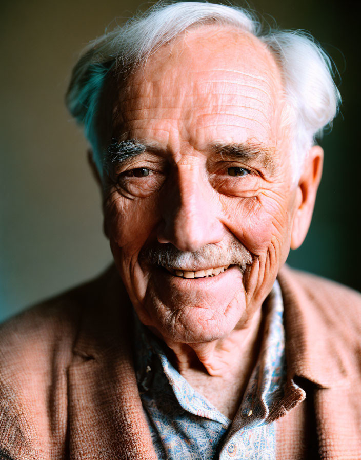 Elderly man with white hair and tweed jacket in portrait