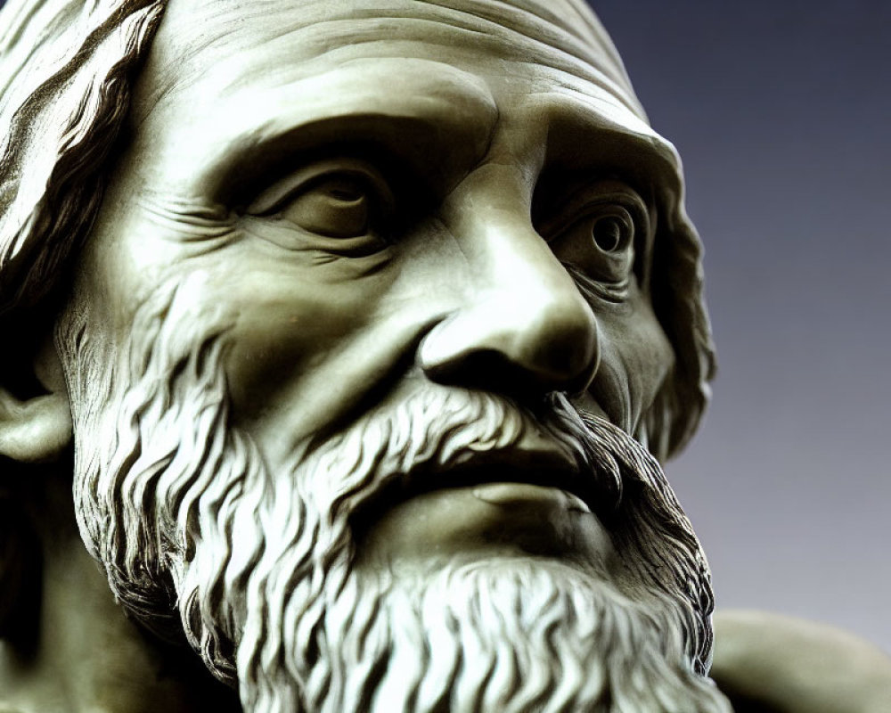 Classical statue of bearded male with deep-set eyes and contemplative expression