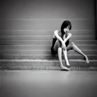 Monochromatic image: Contemplative woman on misty steps with faint sun