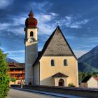 Colorful Fairytale Village Illustration with Patterned Buildings and Flying Butterflies