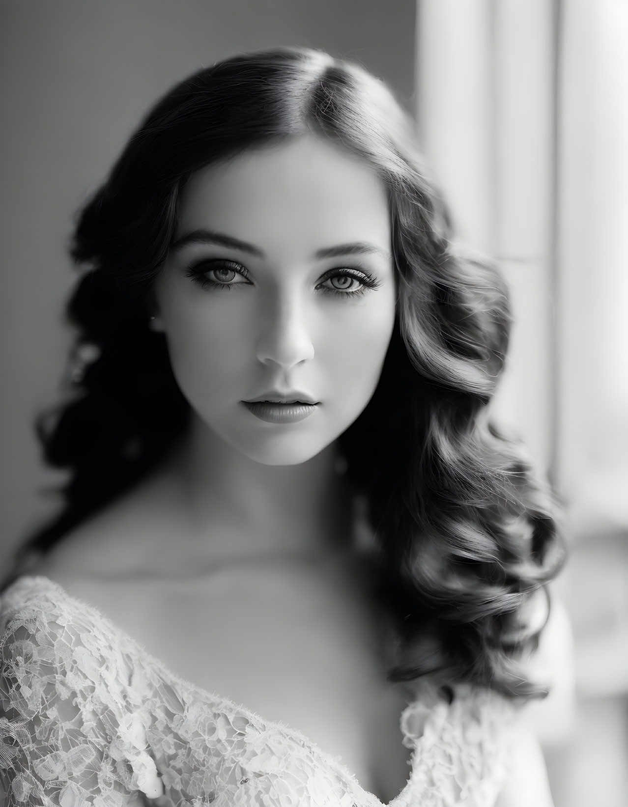 Monochromatic portrait of woman with curly hair and lace attire