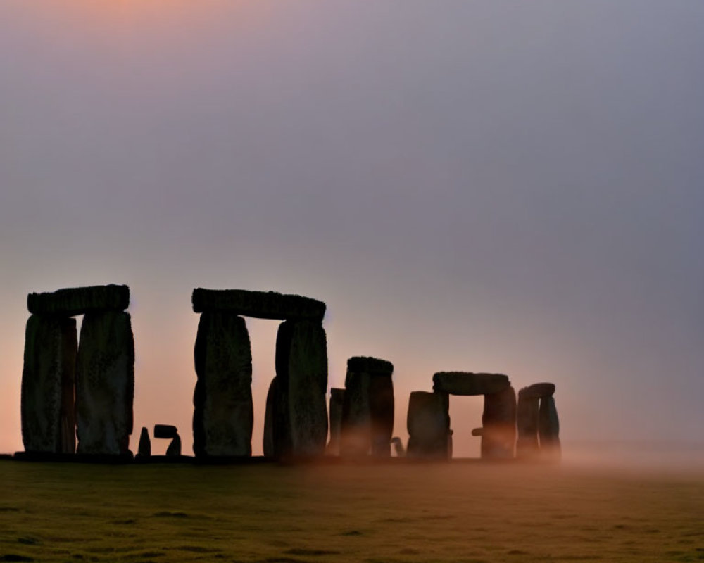 Ancient Stonehenge Silhouettes in Misty Sunrise or Sunset