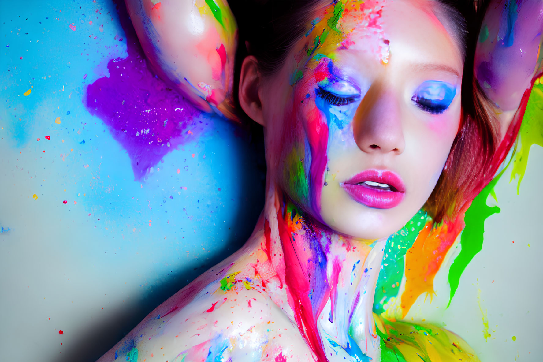 Colorful paint splattered woman with creative makeup on light background