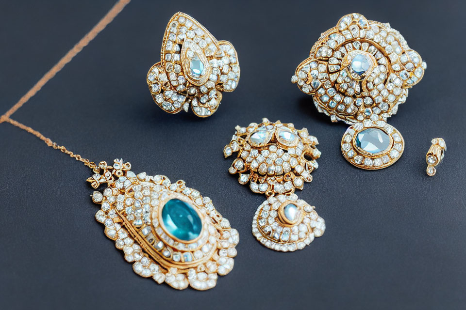 Luxurious Gold Jewelry Set with Turquoise Stones and Diamonds on Black Background