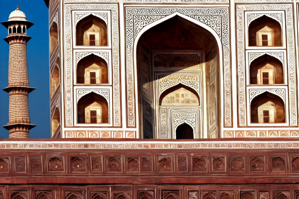 Detailed Mughal architecture with minaret and marble inlay designs