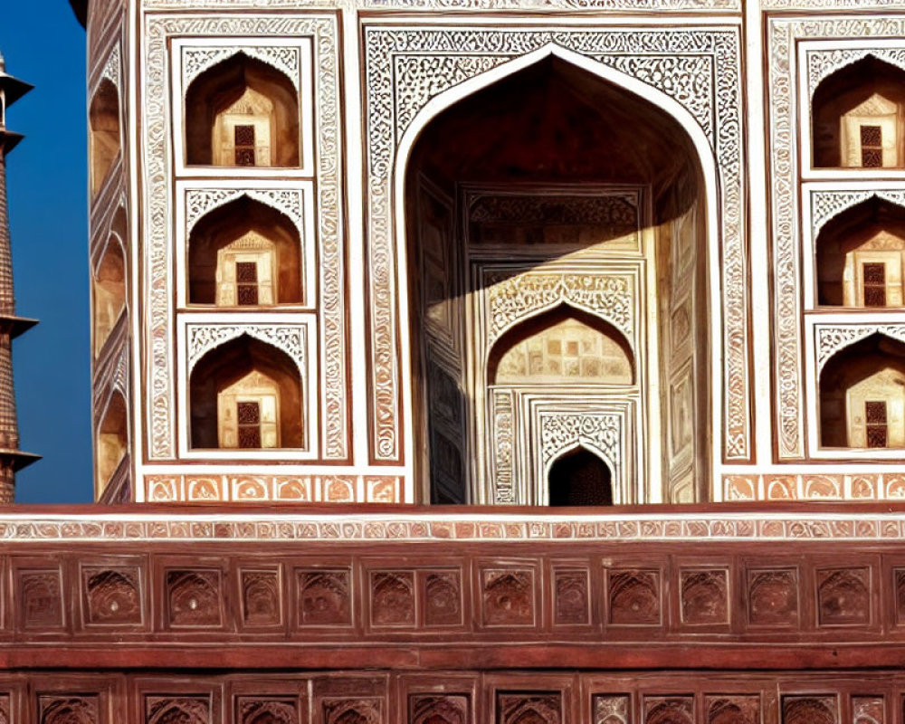 Detailed Mughal architecture with minaret and marble inlay designs