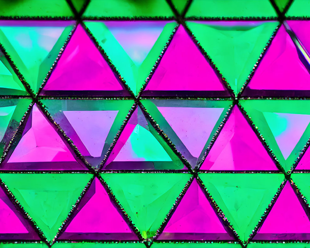 Colorful geometric triangular stained glass window in pink and green.