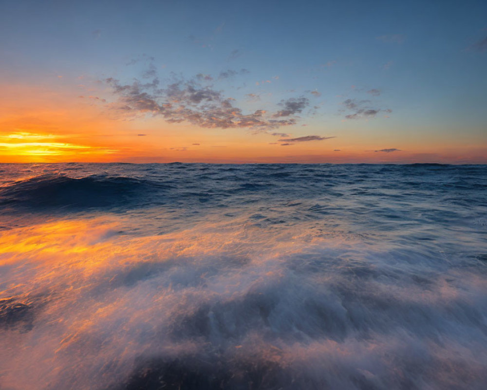 Scenic ocean sunset with fiery skies and rough sea waves