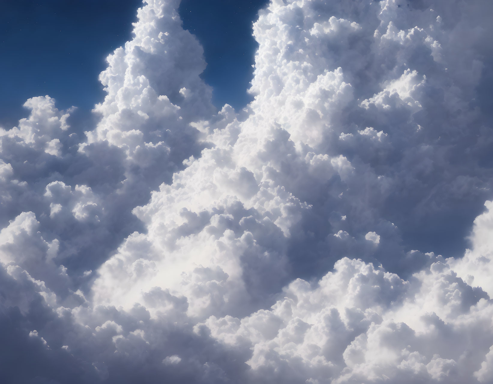 Densely packed fluffy cumulus clouds in deep blue sky