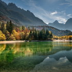 Autumn mountain lake with clear waters and snowy peaks