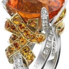 Silver ring with filigree design, orange flowers, and diamond accents