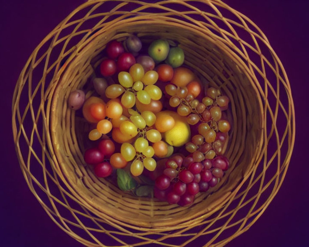 Colorful Grapes in Circular Basket on Dark Purple Background