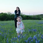 Vintage attired couple in bluebonnet field at sunset