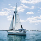 Surreal sailboat with ornate artistic sail on wavy seas