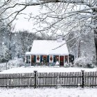 Quaint house with pink door in snowy landscape