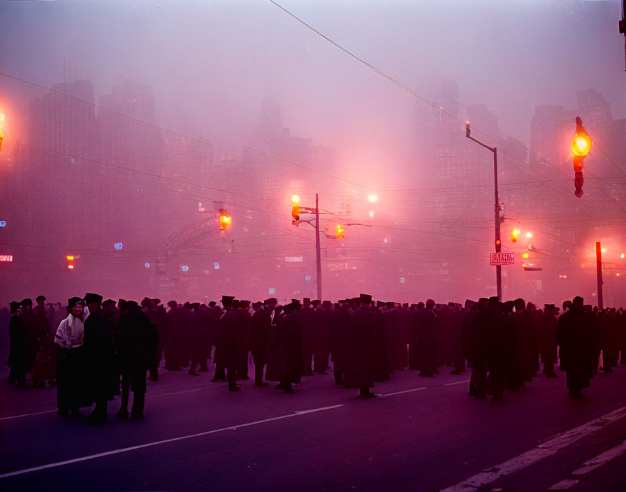 Urban street scene at dusk or dawn with people in dark attire under pink-tinged sky