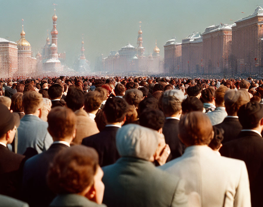 Crowd gathering in square with historical buildings and clear sky