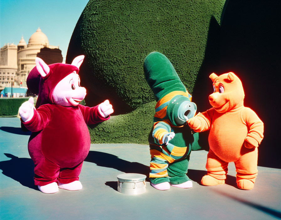 Colorful Costumed Characters in Sunny Outdoor Setting Near Green Structure