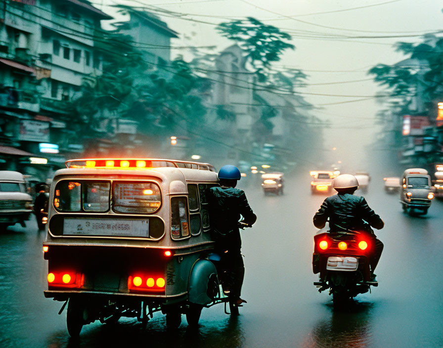 Vehicles on busy street at dusk with motorcycle and small bus in orange-tinged air