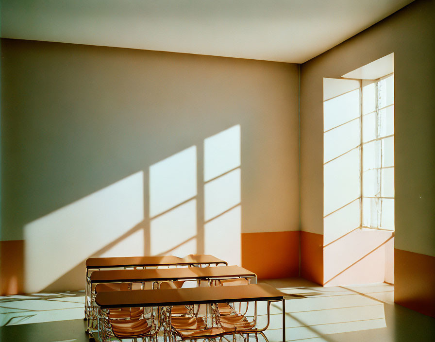 Geometric shadows in room with orange walls and stacked chairs