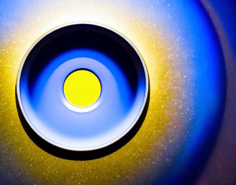 Colorful circular speaker with vibrant yellow center and blue light effects