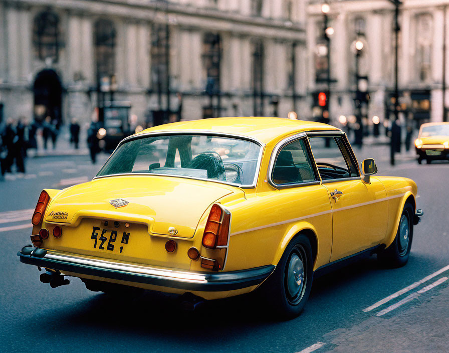 Vintage yellow car parked on city street with blurred pedestrians.