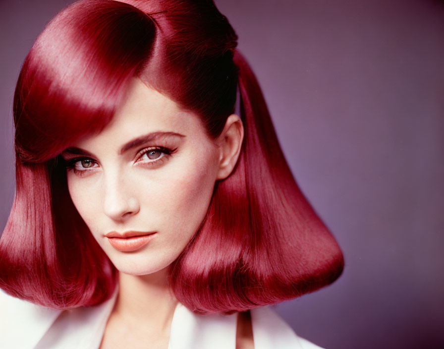 Vibrant red hair woman in white outfit against purple backdrop