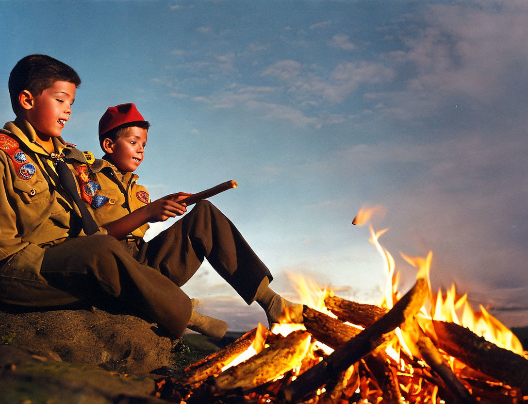 Scouts in uniform by campfire under cloudy sky