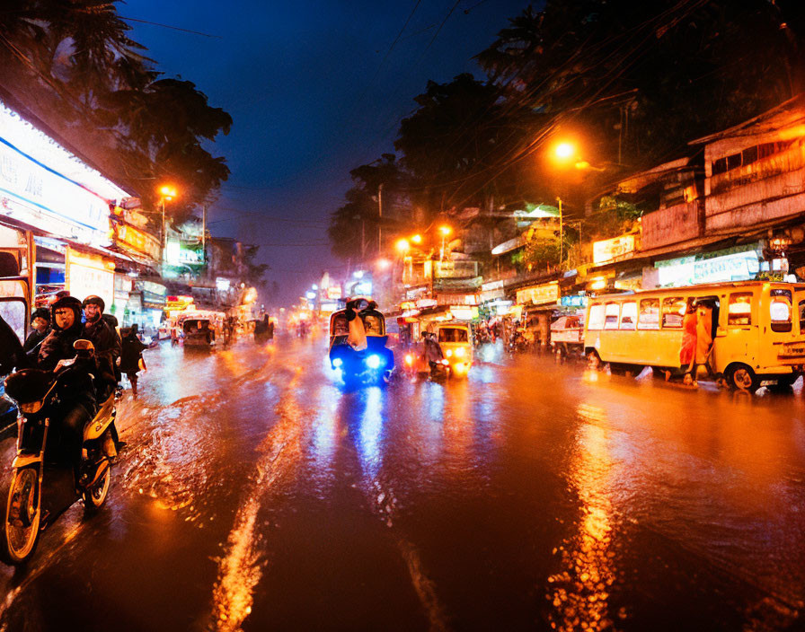 City Street at Night: Wet Pavement, Headlights, Illuminated Shops