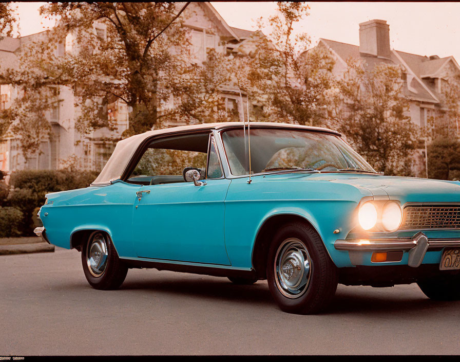 Turquoise Vintage Car Parked on Road at Sunset