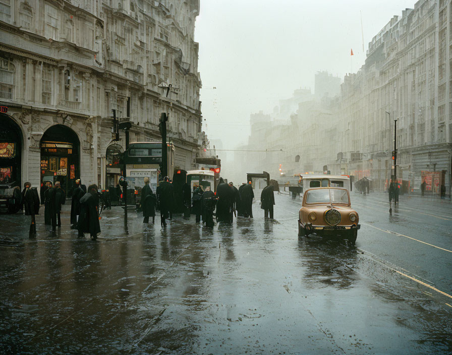 City street scene with classic cars, bus, people, and foggy buildings.