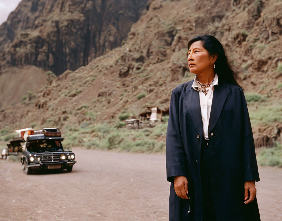 Traditional Attire Woman on Dusty Road with Car and Cliffs