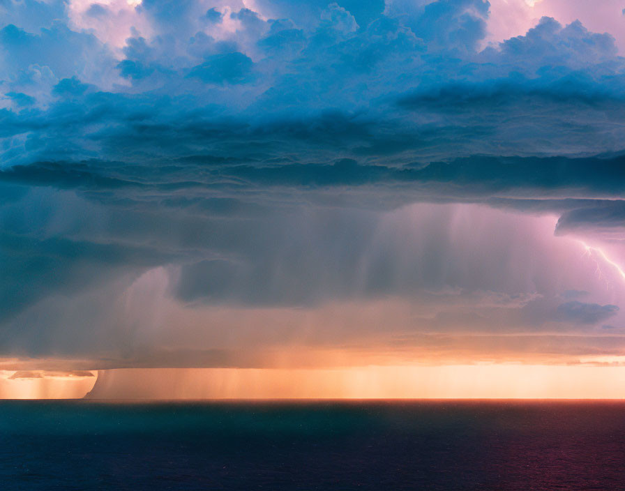 Vibrant seascape with thunderstorm and lightning beneath pink and blue sunset