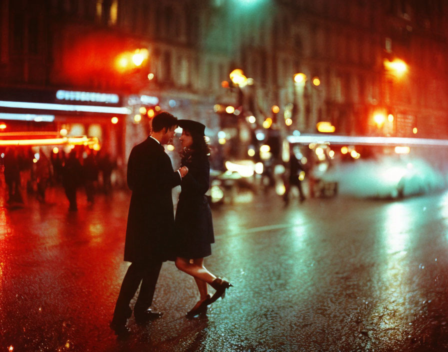 Nighttime city street couple embrace under warm light.