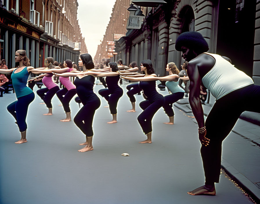 Group of people practicing yoga on urban street led by man