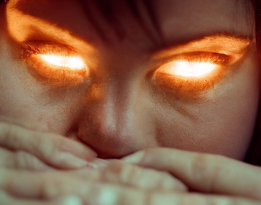 Intense close-up: glowing orange eyes, hands over mouth