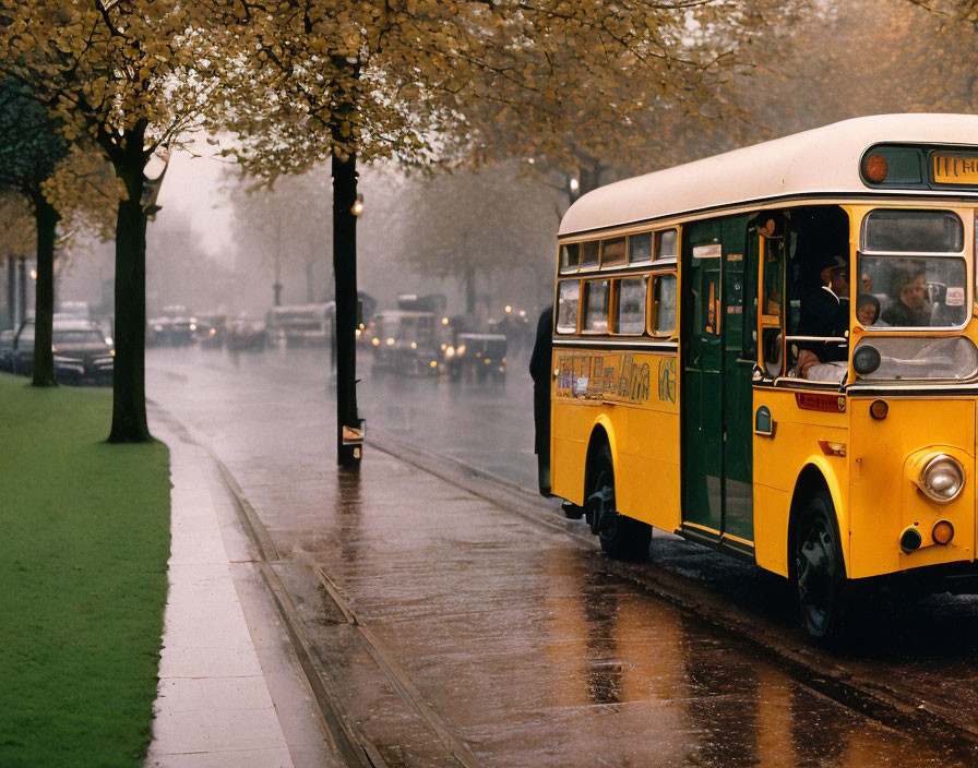 Vintage Yellow Bus on Rain-Slicked Street with Trees and Hazy Backdrop