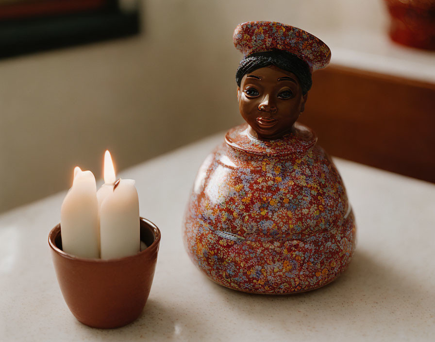 Ceramic woman figurine with floral design and three lit candles on brown holder