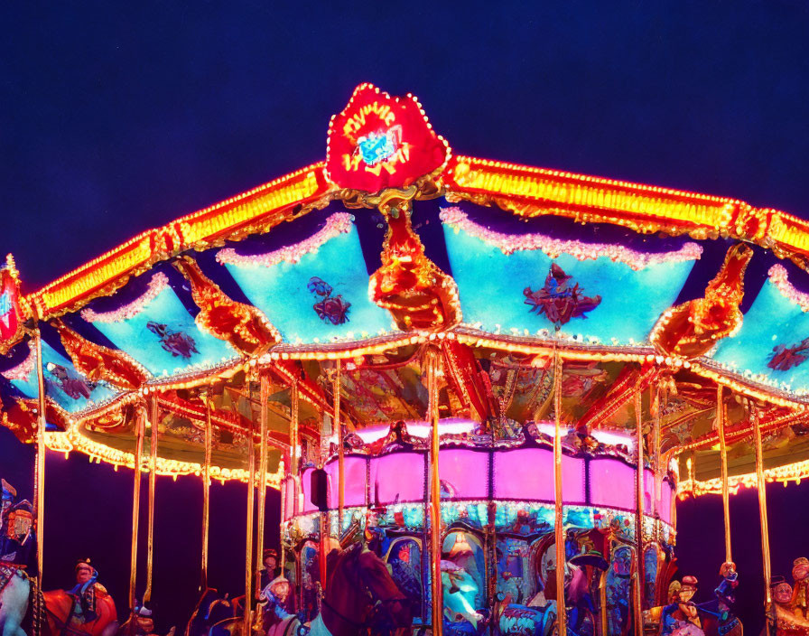 Colorful carousel with ornate decorations and bright lights at night